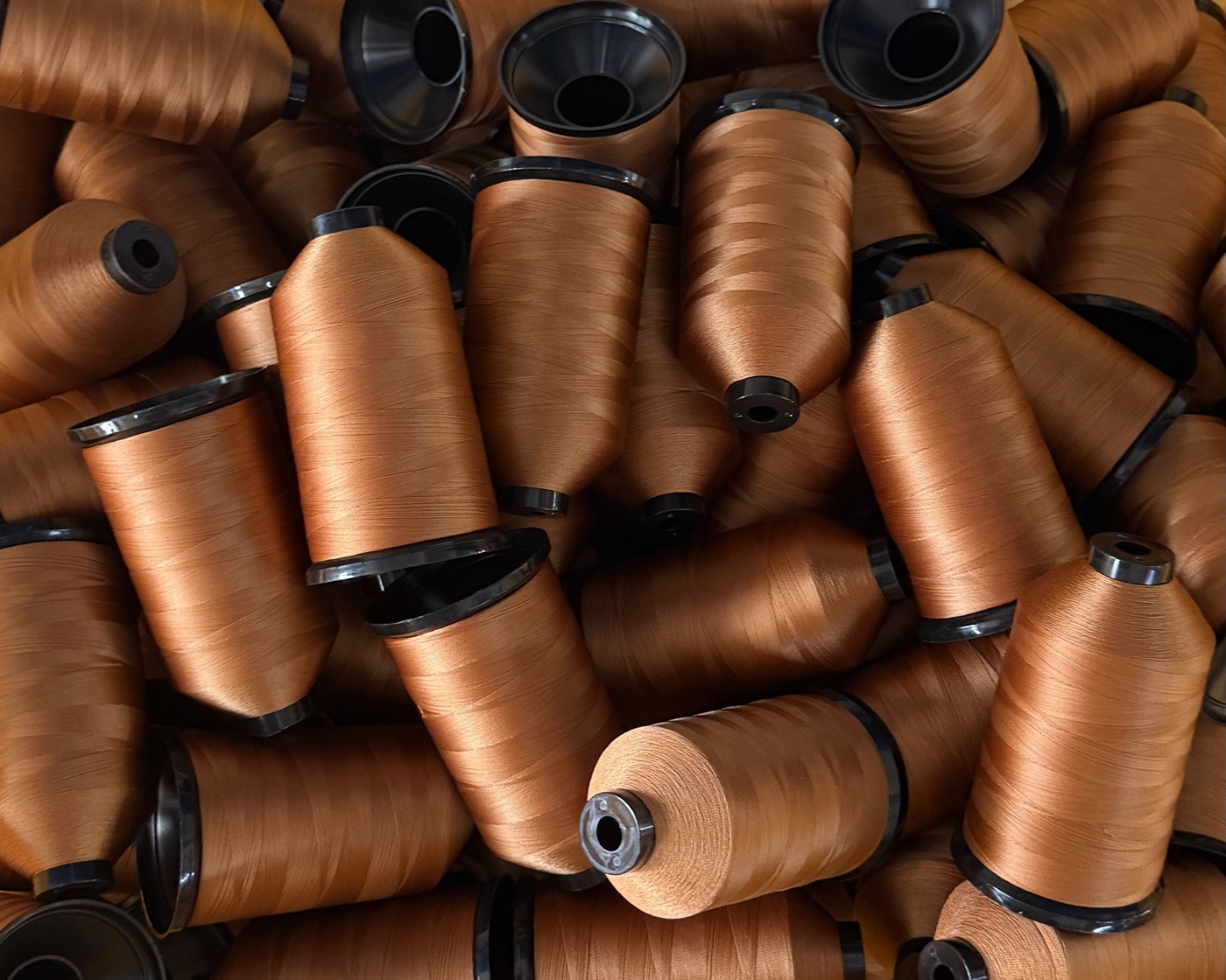 Copper-colored polyester filament sewing thread cones